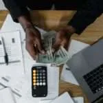 a person counting us dollars
