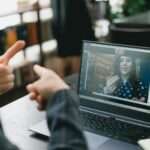 young lady learning sign language during online lesson with female tutor