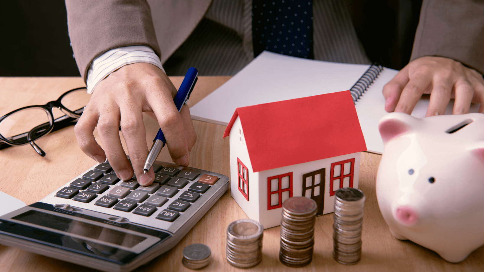Reduce Home Loan EMI vs Reduce Tenure: Which Prepayment Option Can Help? 8 A calculator and a house icon representing home loan EMI and tenure calculations.