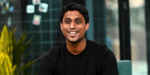 Who Is Ankur Jain? The Wharton-Educated Indian-American Who Built a Billion-Dollar Empire by Making Rent Payments Earn Rewards Ankur Jain transformed America's rental market with Bilt Rewards, turning a massive everyday expense into a loyalty powerhouse. Born to Indian immigrant parents, this entrepreneur scaled his company to over $10 billion valuation, earning billions in personal wealth along the way. Early Life and Roots Ankur Jain was born around 1990 in Bellevue, Washington, to tech entrepreneurs Anu and Naveen Jain, who immigrated from India. Growing up in Redmond near Seattle's tech hub, he showed prodigious talent early; by age 11, he launched MyOnlineQuiz.com. This environment of innovation shaped his path, blending Indian heritage with American opportunity. Jain attended the Wharton School at the University of Pennsylvania, earning a BS in Economics from 2007 to 2011. No IIT connection appears in verified records—his education was firmly U.S.-based, focusing on business amid the 2008 financial crisis. Family ties to India's entrepreneurial spirit, however, fueled his drive, as his father founded InfoSpace. Startup Foundations at Kairos In 2008, as a teen, Jain founded the Kairos Society, an incubator for young entrepreneurs tackling global issues like healthcare and education. Kairos alumni companies raised over $600 million by 2017, valuing at $3 billion combined, and partnered with Obama's Startup America. Jain later evolved it into Kairos HQ, a venture studio growing firms to $6.5 billion total value. Through Kairos, he addressed housing affordability pre-Bilt, launching Rhino to replace security deposits with monthly fees. This hands-on experience honed his skill in scaling solutions for everyday economic pain points. By 2017, after Tinder stints, he refocused Kairos on student debt, housing, and childcare innovations. Pivotal Ventures: Humin and Tinder Jain's first big tech play was Humin in 2012, a smart address book using context like meeting places to organize contacts. He raised $15 million before Tinder acquired it in 2016 as an acqui-hire. Post-acquisition, Jain became VP of Product at Tinder, reportedly developing elite features like Tinder Select for celebrities. These exits built his reputation; Forbes named him to "30 Under 30" in 2015. Humin's contextual tech foreshadowed Bilt's user-centric design, proving Jain's knack for intuitive apps solving real frustrations. Tinder honed product scaling, key for Bilt's rapid growth. Revolutionizing Rent with Bilt Rewards Jain launched Bilt Rewards in 2021 via Kairos, creating the first program letting renters earn points on payments without fees. Partnering with Mastercard and Wells Fargo, the Bilt Mastercard enables fee-free rent via ACH, debit, or credit anywhere in the U.S. Users earn on rent (up to 100,000 points/year) plus neighborhood spends like dining and fitness. Bilt addresses renters' plight: U.S. rents surged, becoming the largest expense for millions in cities like NYC and San Francisco. By 2025, it partnered with 40,000 merchants and 2 million units via multifamily owners. Rewards redeem for travel, flights, dining—building equity toward homeownership. Explosive Growth and Valuation Milestones Bilt hit $1.5 billion valuation shortly after 2021 launch. By January 2024, $3.1 billion after $200 million raise; July 2025 brought $10.75 billion via $250 million from General Catalyst and GID. Targeting $1 billion revenue by Q1 2026, it processes rent/mortgage via multiple methods. Growth stems from network effects: loyalty ecosystem expanded from cards to full home/neighborhood rewards. Over 50 partnerships with property giants represent millions of units. Jain's vision turned "rent burn" into asset-building, disrupting fintech for 40 million U.S. renters. Milestone Date Valuation Funding Raised Launch June 2021 N/A N/A Early Growth 2022-2023 $1.5B Initial rounds Major Raise Jan 2024 $3.1B $200M Latest Round July 2025 $10.75B $250M Recognition and Billionaire Status Forbes pegged Jain's net worth at $3.4 billion in August 2025, up from $1.2 billion in 2024, via 36% Bilt stake. Earlier honors: World Economic Forum Young Global Leader (2017), Inc.'s "Best Connected 21-Year-Old" (2011), multiple "30 Under 30" lists. Hurun Global Rich List highlighted him in 2026 as an Indian-origin billionaire. These nods affirm his authoritativeness in fintech and venture building. Recent buzz ties to WWE via wife Erika Hammond, married in Egypt 2024, blending pop culture with his empire. Impact on Renters and Fintech Landscape Bilt empowers renters, historically fee-trapped (2-3% transaction costs), to earn 1x points on rent—potentially $1,000s yearly in value. It fosters loyalty for landlords via data insights, reducing churn. Broader fintech shift: challenges credit card dominance in payments, promoting inclusive rewards. Economic ripple: aids wealth-building for non-homeowners, narrowing inequality gaps. Partnerships with airlines/hotels amplify value, turning expense into travel perks. Jain's model proves "loyalty for necessities" scales massively. Future Vision and Legacy Jain eyes Bilt as a "full loyalty ecosystem," expanding to mortgages and beyond. Kairos continues incubating impact ventures. His story inspires Indian-American youth: from immigrant kid to billionaire solving trillion-dollar problems. Personal life adds relatability—tennis, music, volunteering. Legacy: proving everyday payments can fuel empires, with Bilt eyeing unicorn revenue paces.